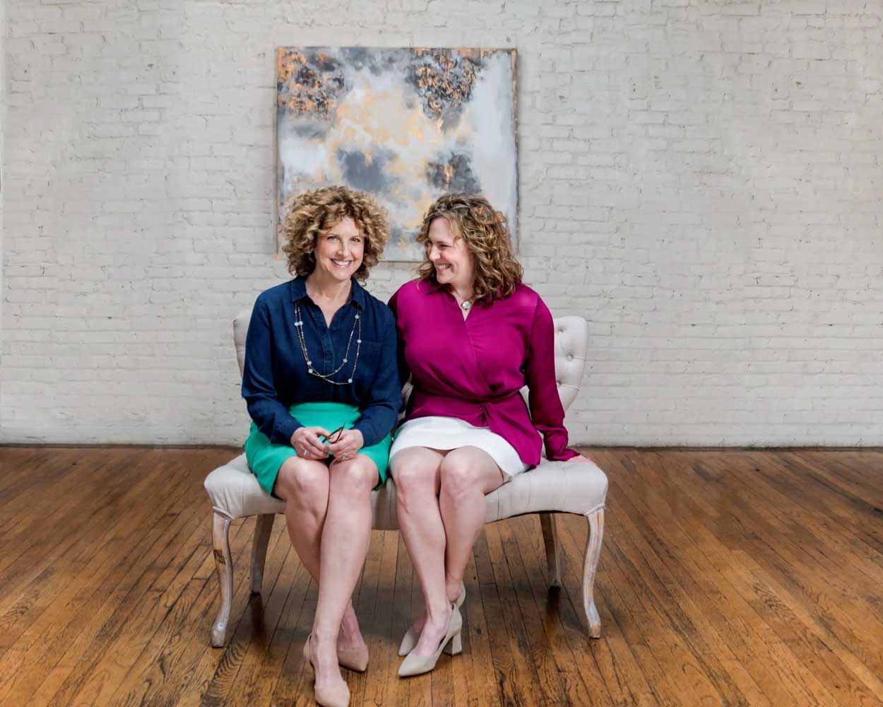 julie and lisa sitting together smiling